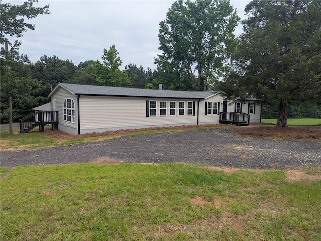 732 Five Points Rd, Buchanan, GA 30113 - manufactured / mobile home featuring a front yard, a wooden deck, and gravel driveway
