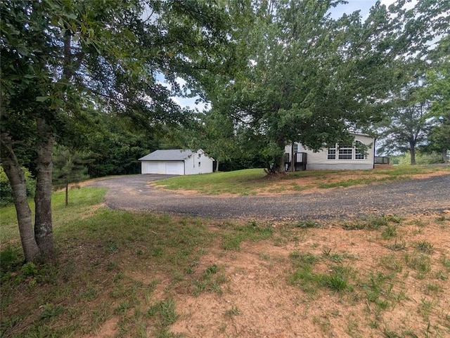 732 Five Points Rd, Buchanan, GA 30113 - view of grassy yard featuring an outdoor structure and a detached garage