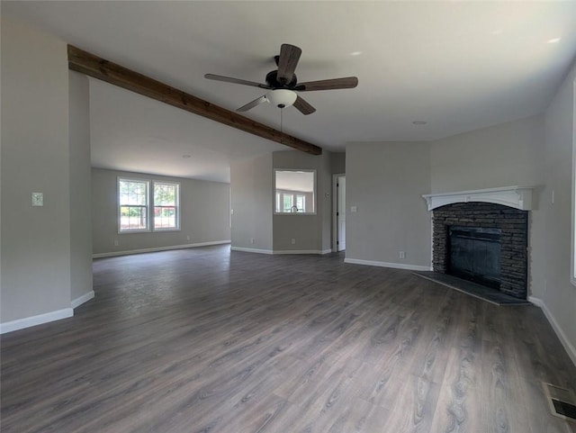 732 Five Points Rd, Buchanan, GA 30113 - unfurnished living room with a ceiling fan, healthy amount of natural light, beamed ceiling, wood finished floors, and a stone fireplace