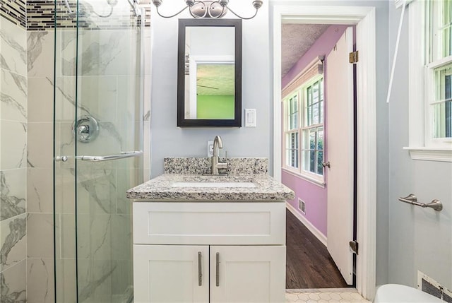 1663 Pounds Rd SW, Stone Mountain, GA 30087 - bathroom featuring a marble finish shower, vanity, toilet, and wood finished floors