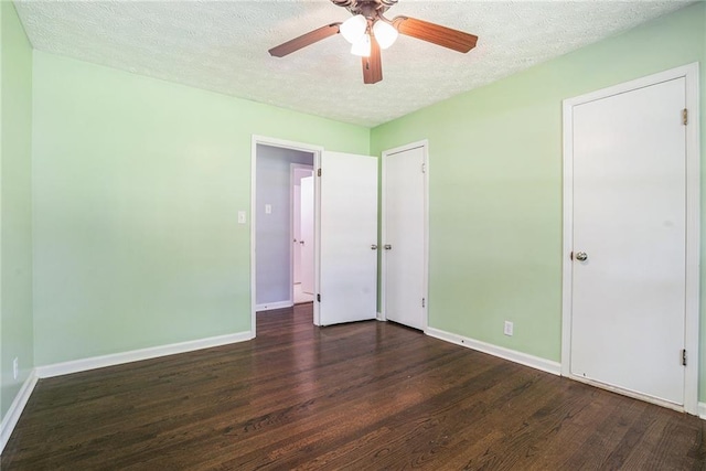 1663 Pounds Rd SW, Stone Mountain, GA 30087 - unfurnished bedroom with a textured ceiling, wood finished floors, baseboards, and a ceiling fan