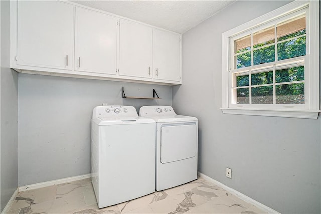 1663 Pounds Rd SW, Stone Mountain, GA 30087 - washroom featuring cabinet space, light marble finish flooring, separate washer and dryer, baseboards, and a textured ceiling