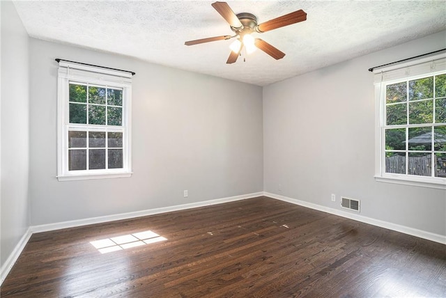1663 Pounds Rd SW, Stone Mountain, GA 30087 - empty room with dark wood-style flooring, plenty of natural light, baseboards, a textured ceiling, and ceiling fan