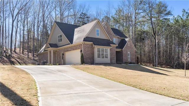 25 Mountain Crest Dr, Oxford, GA 30054 - view of front of home with concrete driveway, cooling unit, an attached garage, a front yard, and brick siding