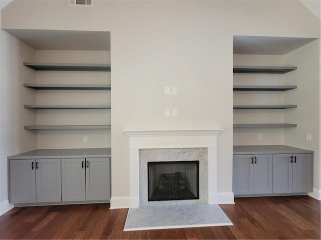 25 Mountain Crest Dr, Oxford, GA 30054 - unfurnished living room with dark wood-type flooring, a premium fireplace, baseboards, and visible vents