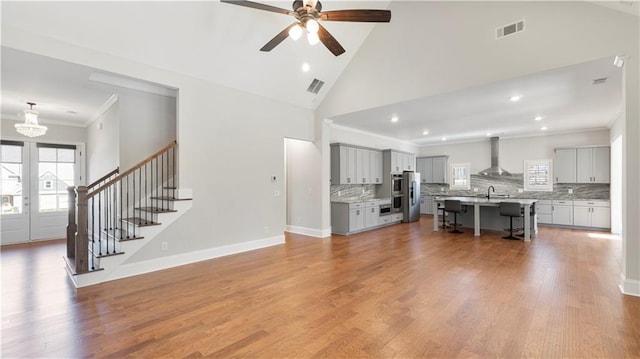 25 Mountain Crest Dr, Oxford, GA 30054 - living area with stairs, visible vents, ceiling fan with notable chandelier, and ornamental molding
