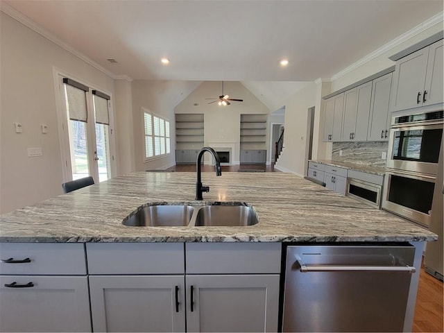 25 Mountain Crest Dr, Oxford, GA 30054 - kitchen with a sink, open floor plan, a ceiling fan, a kitchen island with sink, and stainless steel appliances