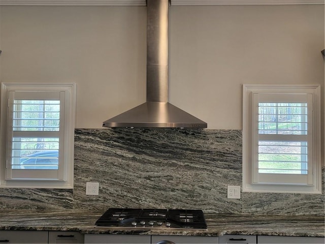 25 Mountain Crest Dr, Oxford, GA 30054 - details featuring dark stone countertops, decorative backsplash, stainless steel gas stovetop, and wall chimney exhaust hood