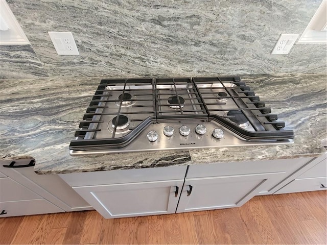 25 Mountain Crest Dr, Oxford, GA 30054 - room details with white cabinets, stainless steel gas cooktop, and wood finished floors