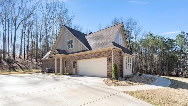 25 Mountain Crest Dr, Oxford, GA 30054 - view of home's exterior featuring roof with shingles, brick siding, driveway, and board and batten siding