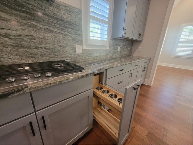 25 Mountain Crest Dr, Oxford, GA 30054 - kitchen featuring tasteful backsplash, baseboards, stainless steel gas stovetop, dark wood-type flooring, and light stone counters
