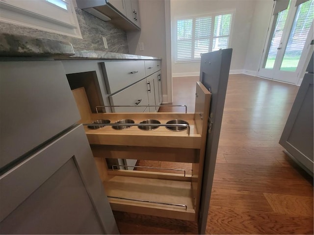 25 Mountain Crest Dr, Oxford, GA 30054 - details with white cabinetry, wood finished floors, light countertops, decorative backsplash, and baseboards