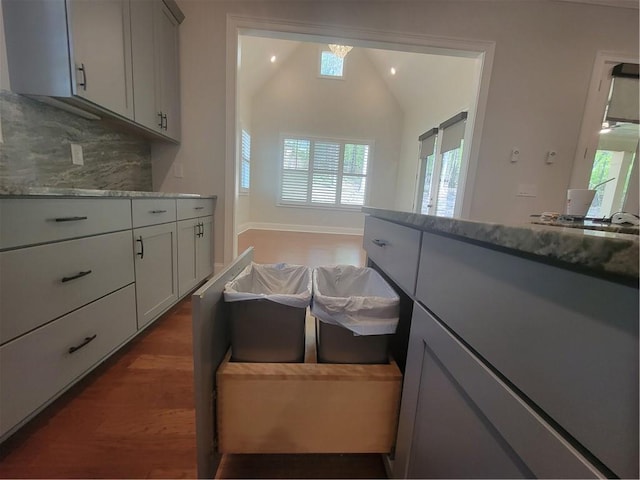 25 Mountain Crest Dr, Oxford, GA 30054 - kitchen featuring light stone countertops, tasteful backsplash, vaulted ceiling, wood finished floors, and a sink