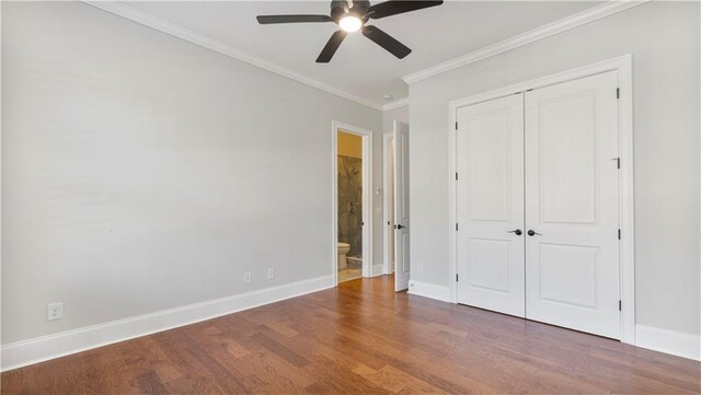 25 Mountain Crest Dr, Oxford, GA 30054 - unfurnished bedroom with baseboards, a closet, ornamental molding, and wood finished floors