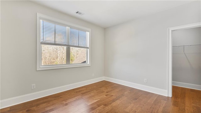 25 Mountain Crest Dr, Oxford, GA 30054 - unfurnished bedroom with a closet, baseboards, a spacious closet, visible vents, and wood finished floors