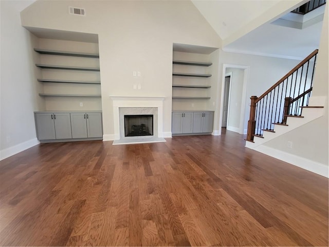 25 Mountain Crest Dr, Oxford, GA 30054 - unfurnished living room with built in features, baseboards, visible vents, wood finished floors, and a premium fireplace