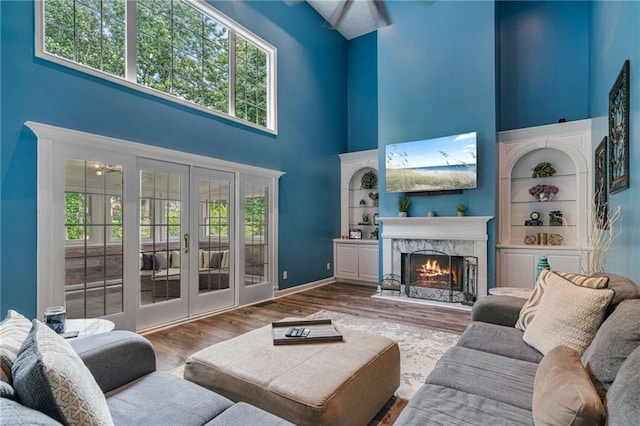 340 Chandler Ct, Sugar Hill, GA 30518 - living area with a towering ceiling, french doors, healthy amount of natural light, and wood finished floors