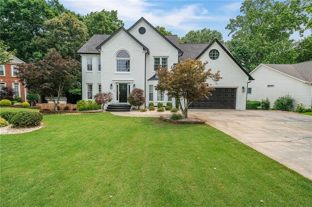 340 Chandler Ct, Sugar Hill, GA 30518 - view of front facade featuring driveway, a front lawn, and a garage