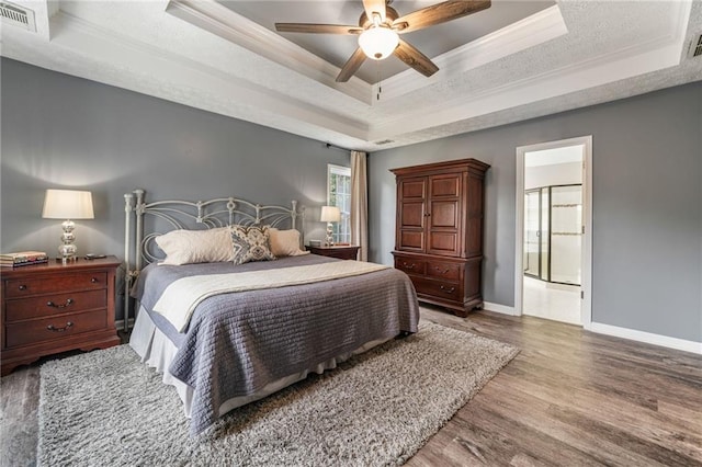340 Chandler Ct, Sugar Hill, GA 30518 - bedroom with a tray ceiling, ornamental molding, baseboards, wood finished floors, and ceiling fan