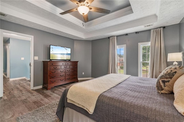 340 Chandler Ct, Sugar Hill, GA 30518 - bedroom featuring a raised ceiling, wood finished floors, baseboards, ornamental molding, and a ceiling fan