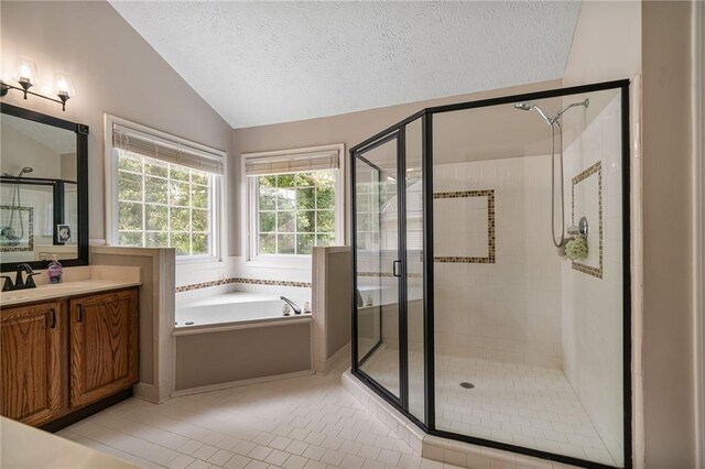 340 Chandler Ct, Sugar Hill, GA 30518 - bathroom featuring lofted ceiling, a stall shower, a bath, vanity, and tile patterned flooring