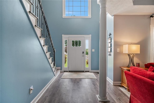 340 Chandler Ct, Sugar Hill, GA 30518 - foyer entrance featuring wood finished floors, a towering ceiling, plenty of natural light, baseboards, and stairway