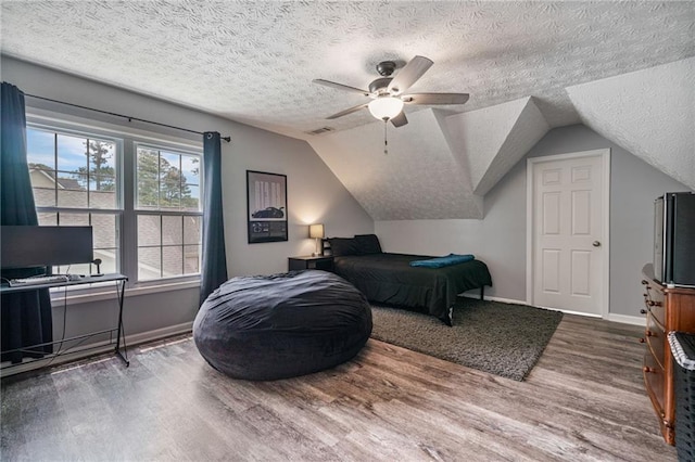 340 Chandler Ct, Sugar Hill, GA 30518 - bedroom with wood finished floors, a textured ceiling, baseboards, lofted ceiling, and a ceiling fan