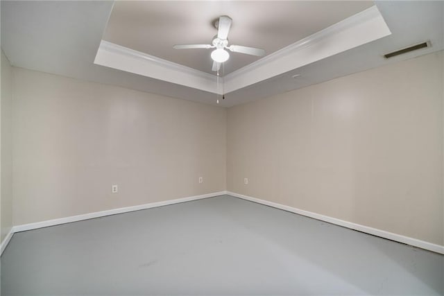 340 Chandler Ct, Sugar Hill, GA 30518 - spare room with a tray ceiling, concrete floors, a ceiling fan, ornamental molding, and baseboards