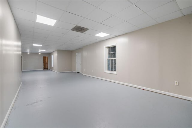 340 Chandler Ct, Sugar Hill, GA 30518 - spare room featuring a drop ceiling, baseboards, and finished concrete flooring
