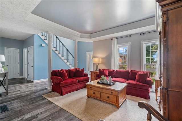 340 Chandler Ct, Sugar Hill, GA 30518 - living area with wood finished floors, a tray ceiling, stairs, baseboards, and ornamental molding