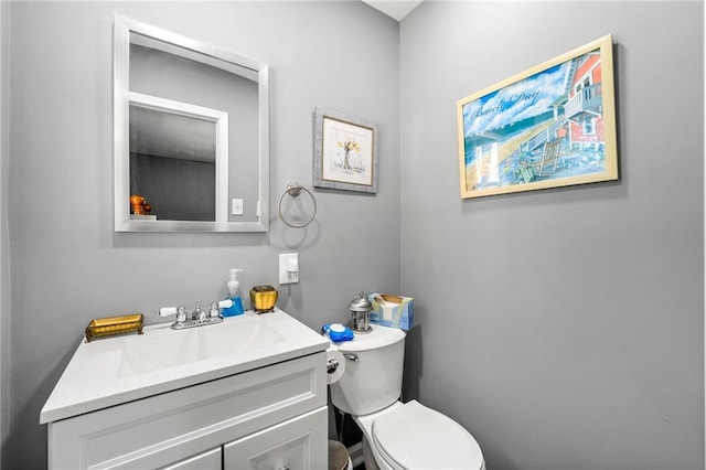 bathroom featuring toilet and vanity