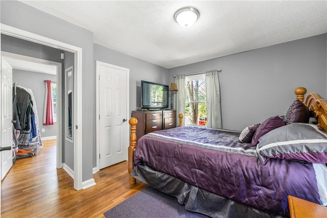 bedroom featuring hardwood / wood-style flooring and a textured ceiling