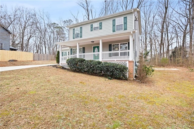 view of front of property featuring covered porch and a front yard