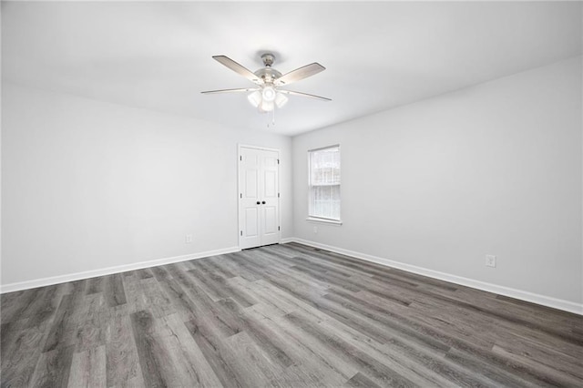 spare room featuring wood-type flooring and ceiling fan