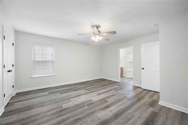 unfurnished room featuring ceiling fan and dark hardwood / wood-style floors