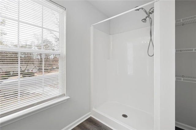 bathroom featuring hardwood / wood-style floors and walk in shower