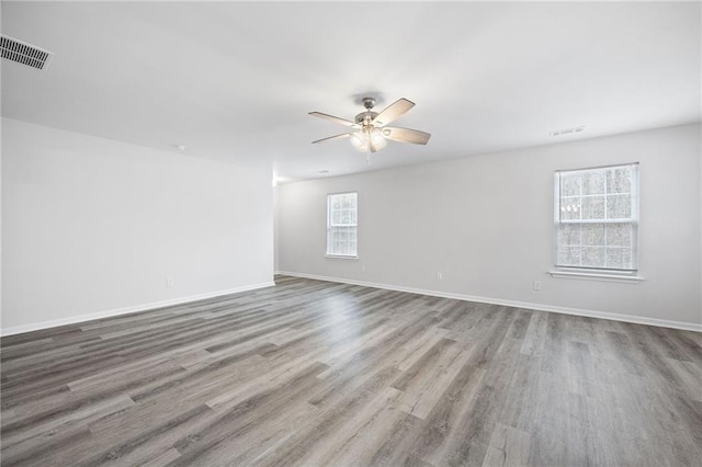 spare room featuring light hardwood / wood-style flooring and ceiling fan