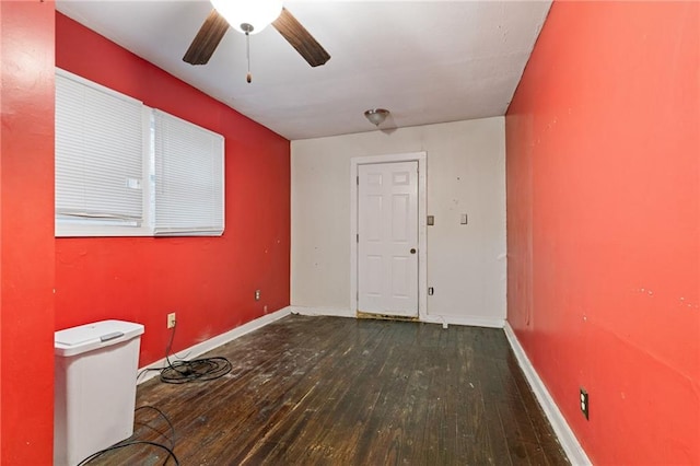 unfurnished room featuring a ceiling fan, hardwood / wood-style flooring, and baseboards