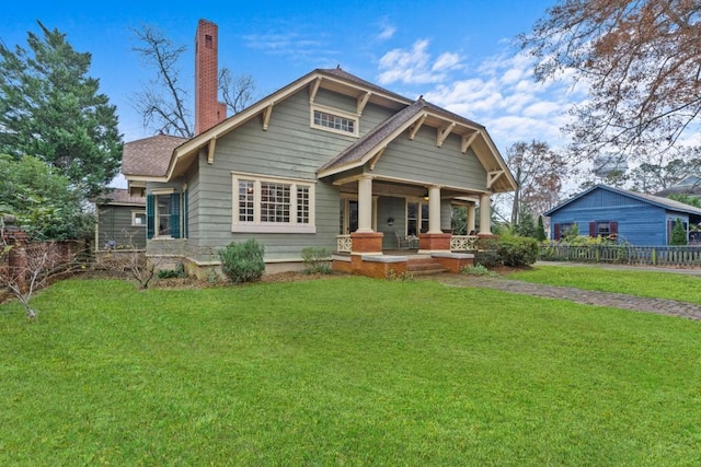 craftsman house featuring a front lawn and a porch