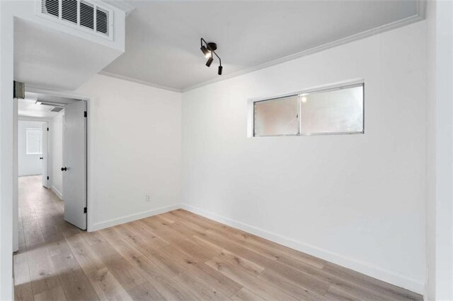 91 Rumson Rd Unit C 30, Atlanta, GA 30305 - spare room with ornamental molding, wood finished floors, baseboards, and rail lighting