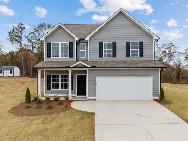 traditional-style home featuring a garage, concrete driveway, and a front yard