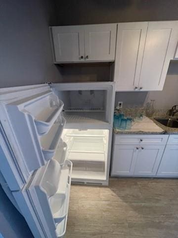 kitchen with white cabinetry and sink