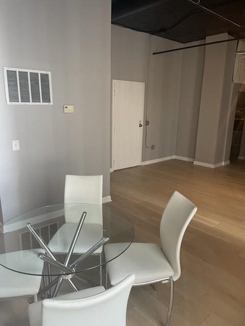 dining room with wood-type flooring