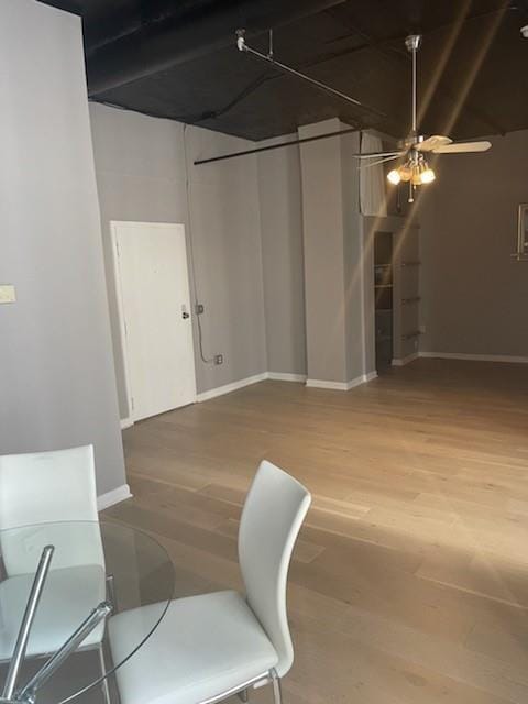 unfurnished dining area featuring hardwood / wood-style flooring and ceiling fan