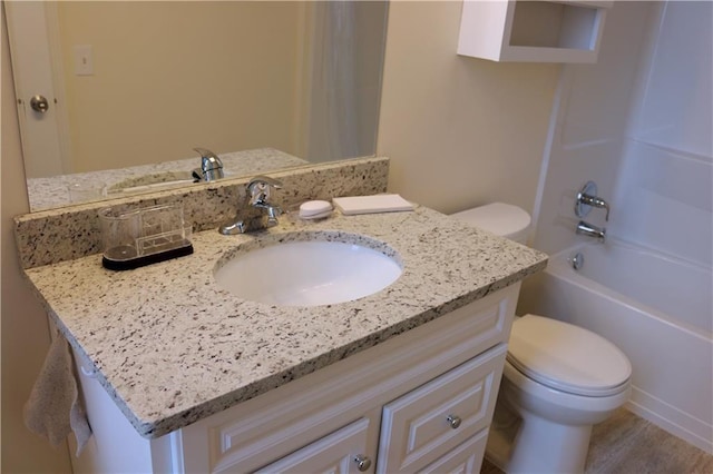 full bathroom with vanity, hardwood / wood-style flooring, toilet, and shower / bath combination