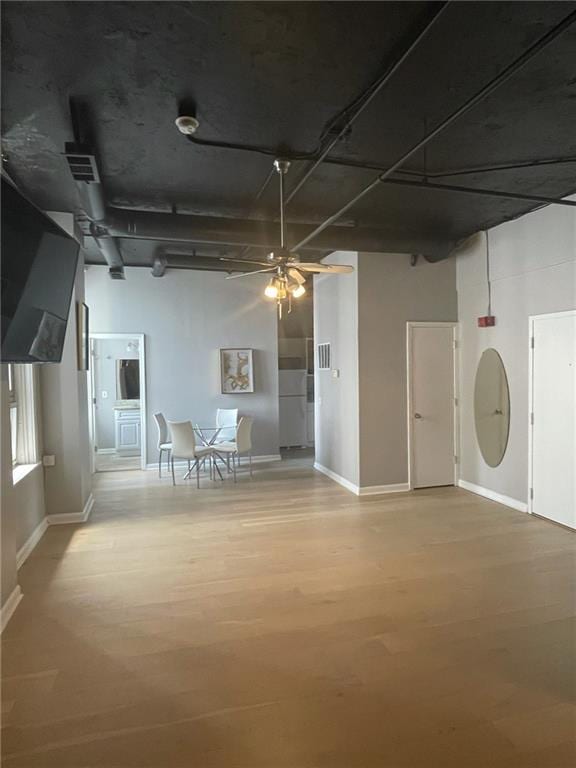 basement with ceiling fan and hardwood / wood-style floors