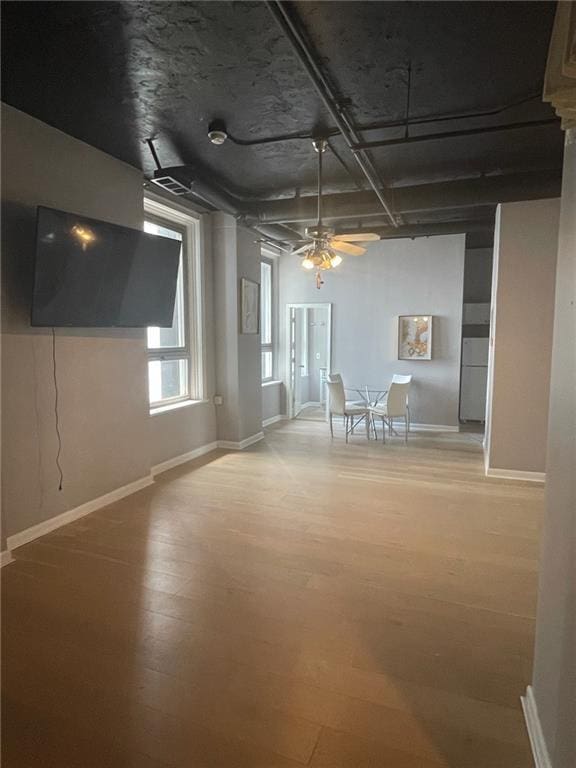 basement featuring ceiling fan and light wood-type flooring