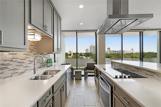 kitchen with light tile patterned floors, sink, dishwasher, island range hood, and oven