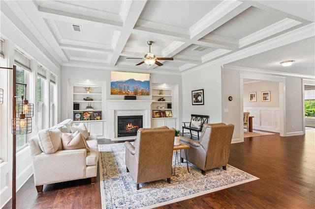 4972 Park Vale Dr, Sugar Hill, GA 30518 - living room with a glass covered fireplace, dark wood finished floors, a ceiling fan, built in features, and beamed ceiling