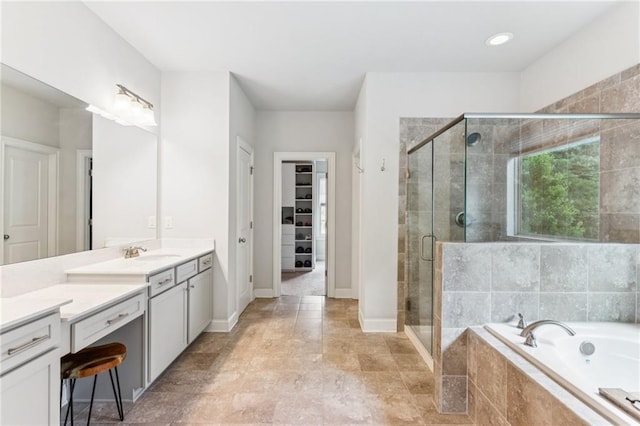 4972 Park Vale Dr, Sugar Hill, GA 30518 - bathroom featuring vanity, a bath, a stall shower, and a walk in closet